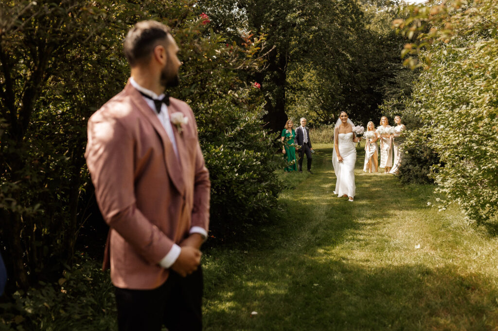 groom looking at his bride walking down for the first time