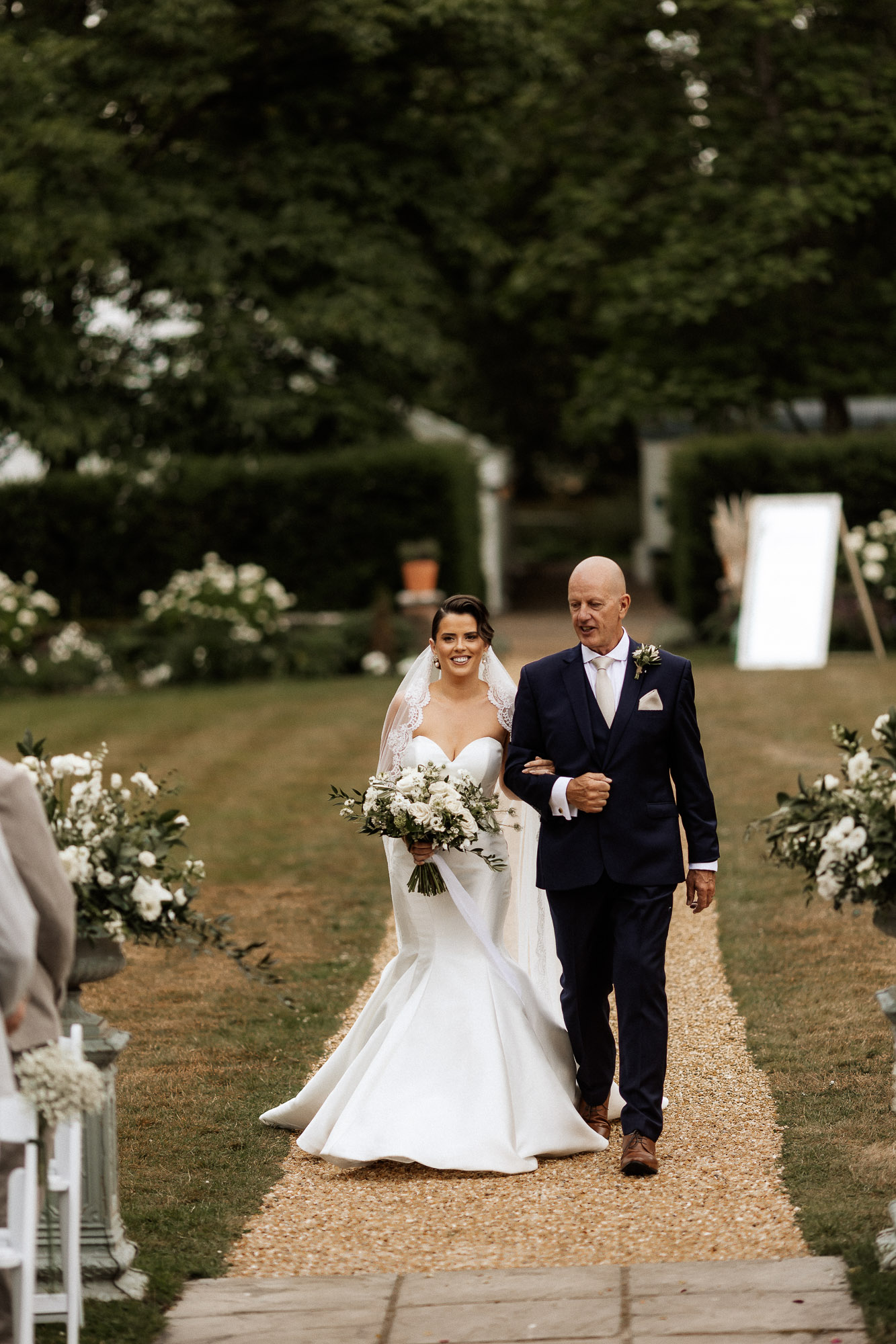 bride and father of bride walking dow the aisle at deans court
