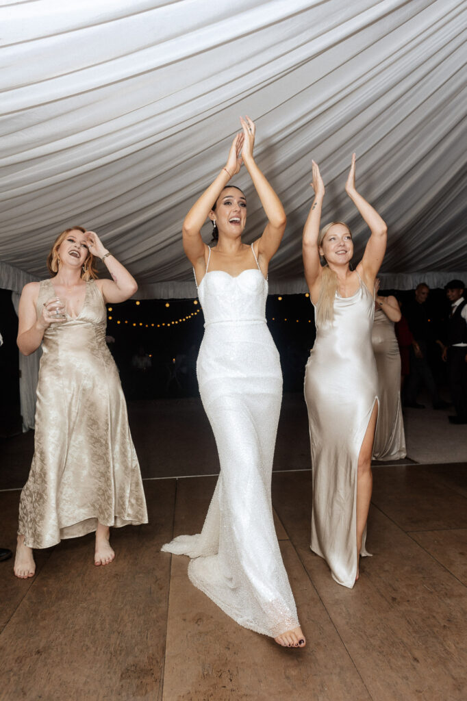 bride and her bridesmaids dancing